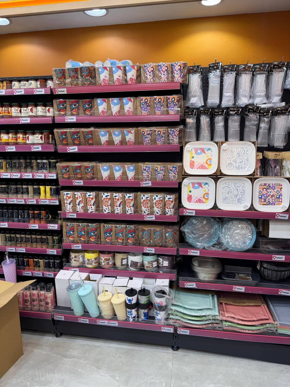 Printed cups, plates, and tumblers on a retail shelf