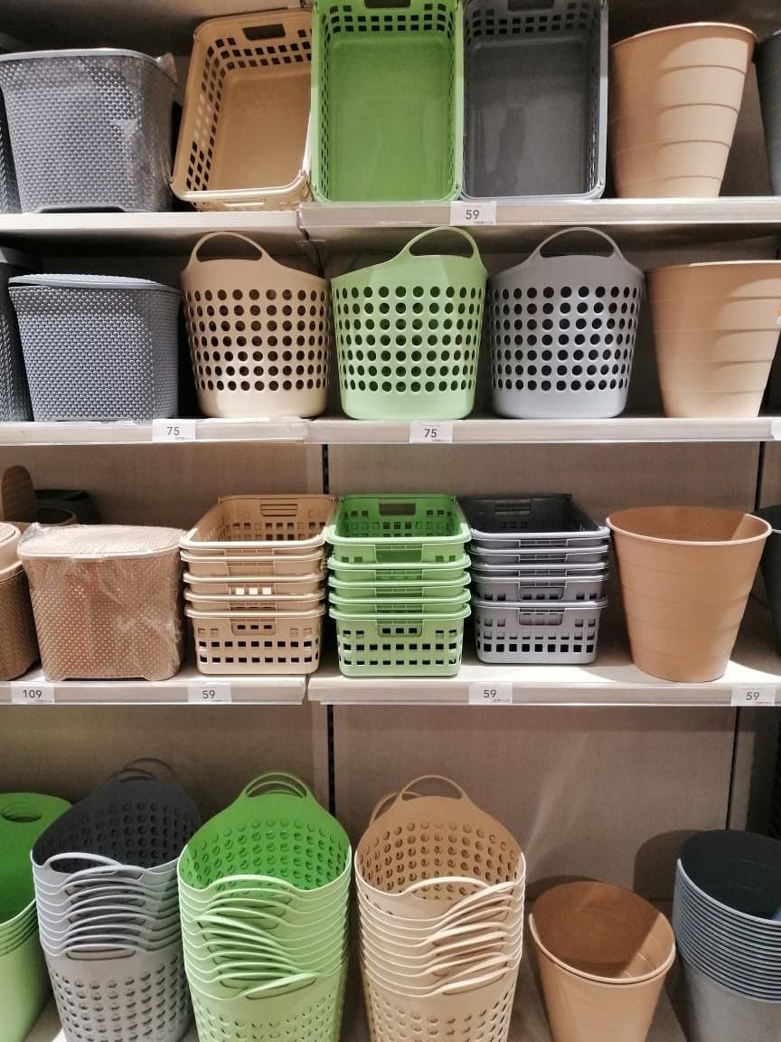 Plastic baskets and bins arranged on store shelves